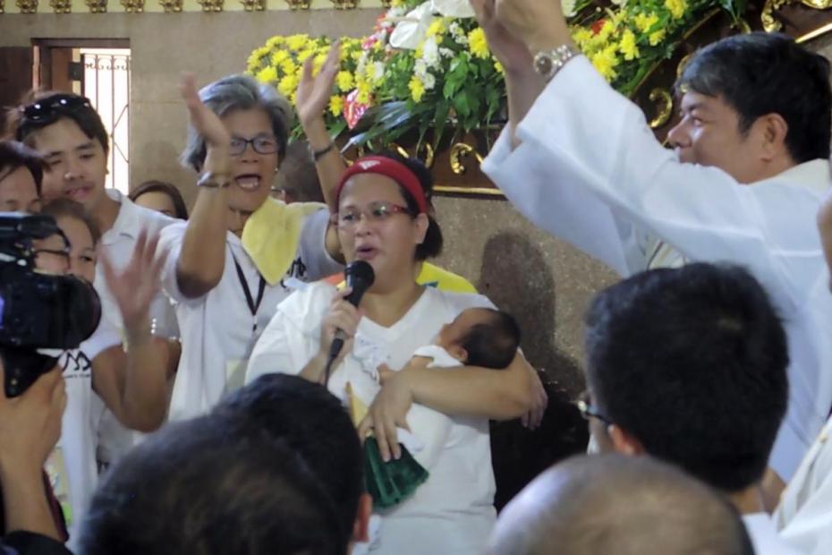 This woman presented her "miracle baby" to the parish, and spoke of how many years she'd been trying to conceive before her presence at the feast finally brought a child.