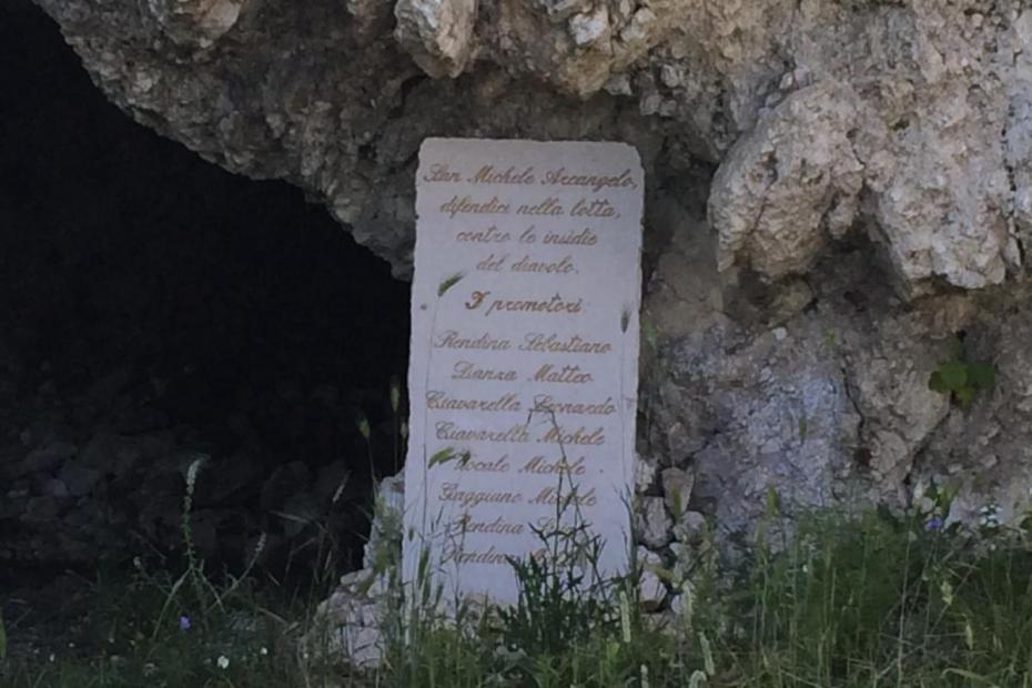 On a road to San Michele in Gargano, a stone at a small cave reads "Saint Michael Archangel, defend us in the fight against the insidiousness of the devil," and names some of the Archangel's promotors.