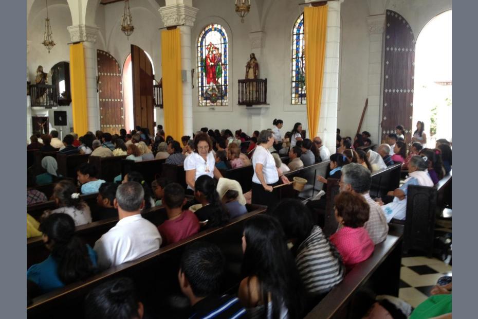 Mass at the opening of the Cristo Negro Feast, Juayúa, El Salvador. Other than the priest, all of the roles at Mass from collection, to acolytes, lectors and Eucharistic ministers were taken by women.